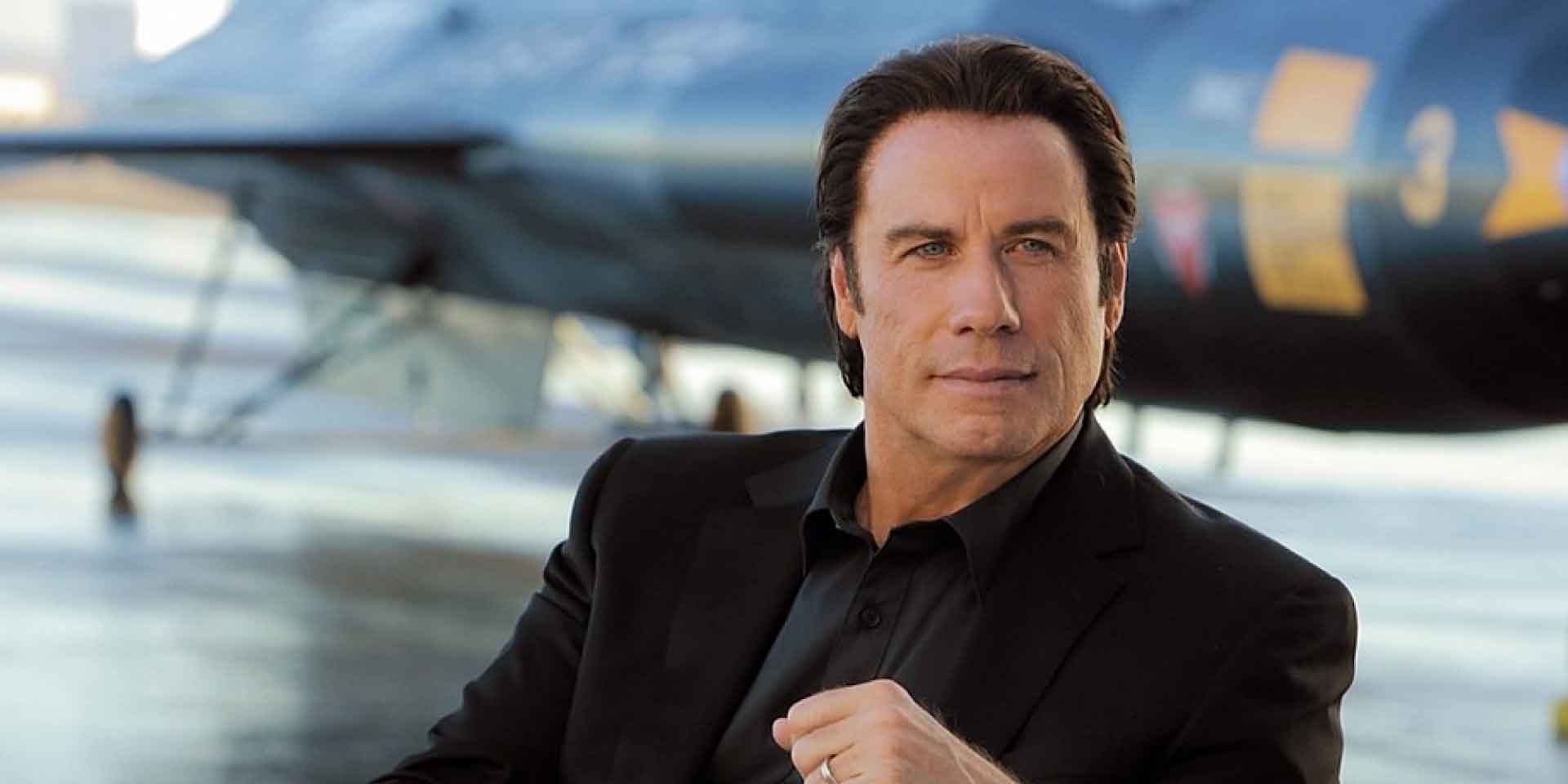 Why does John Travolta wear wigs?