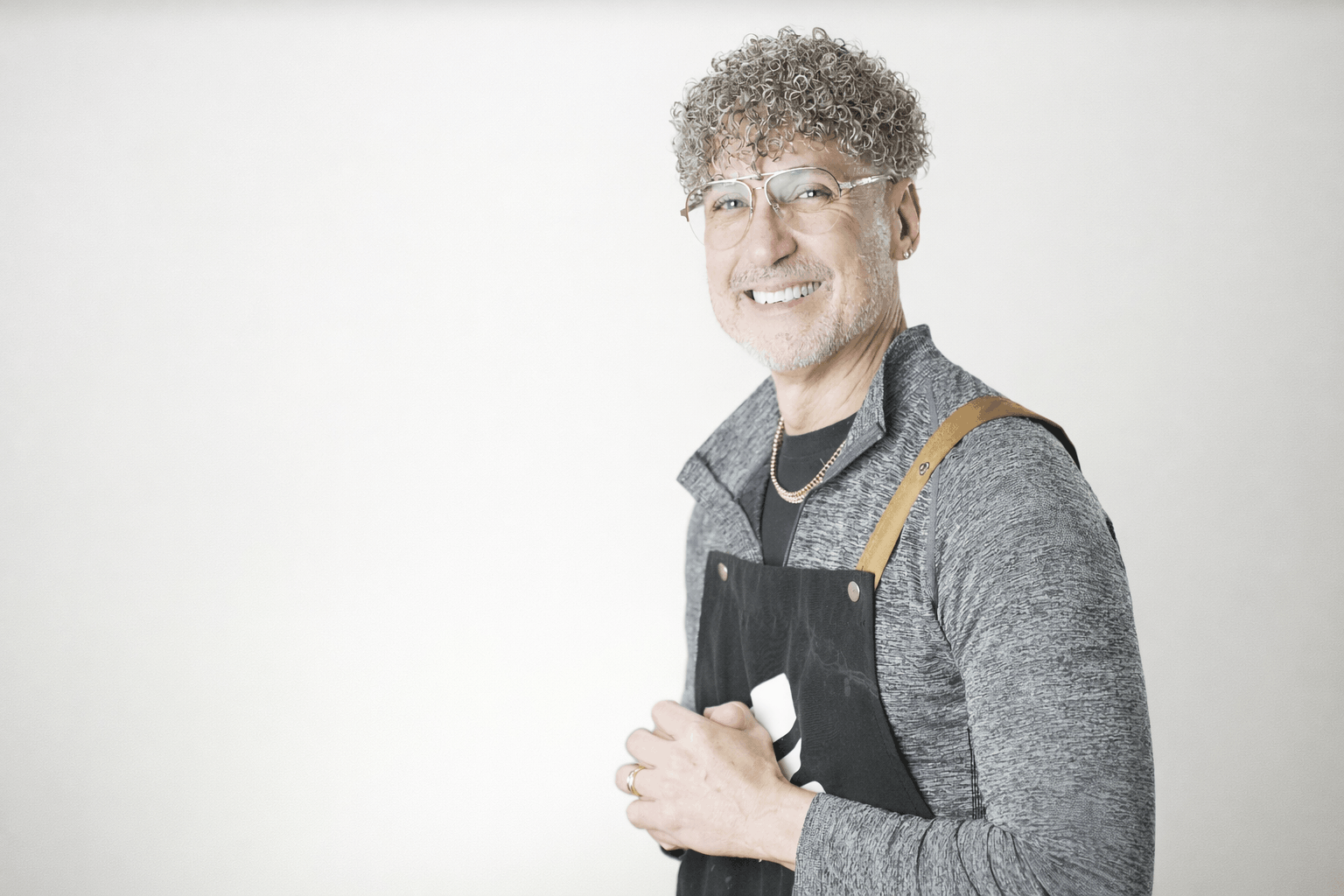 stylist wearing a curly toupee